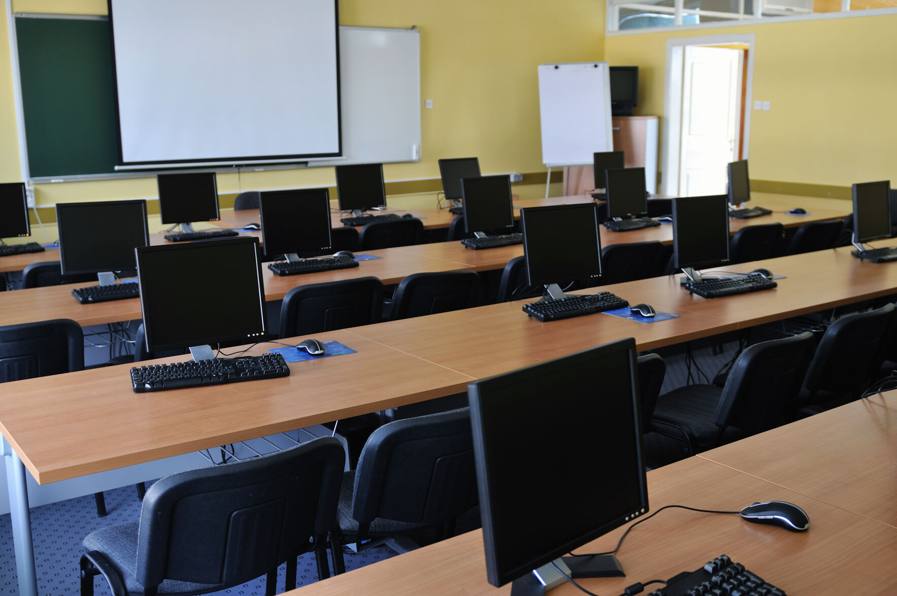 School classroom with smart board and computers